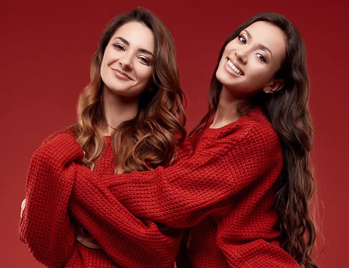 Photo of Two women in red hugging