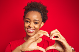 Photo of Smiling woman with her hands in shape of a heart